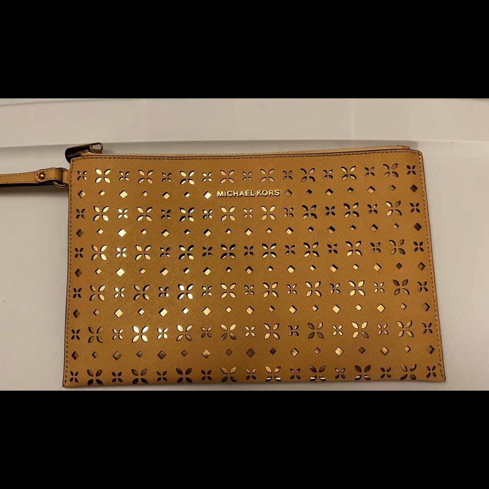 Golden perforated Michael Kors XL wristlet. Never used. New without tags